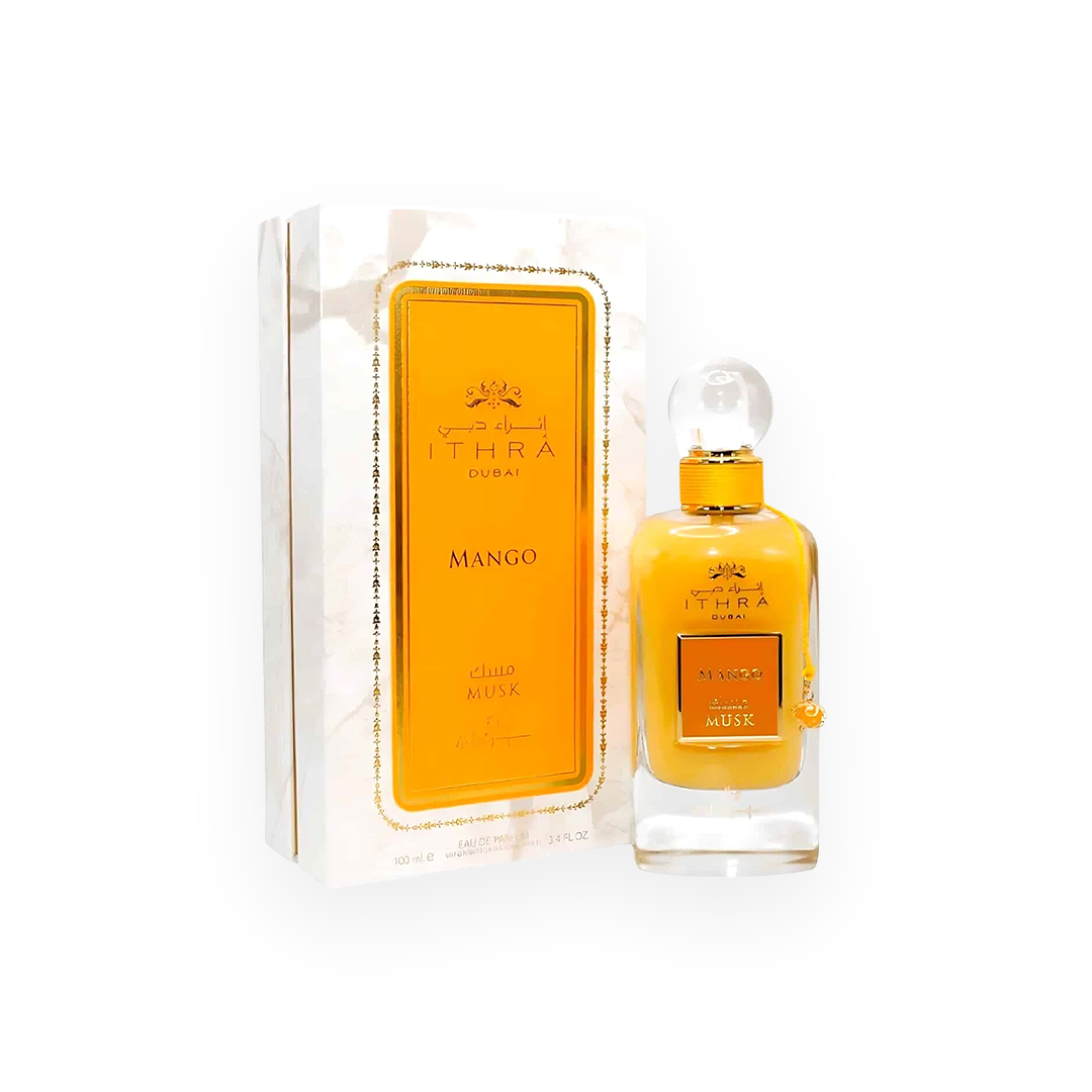 Packshot du parfum Mango Musk 100 ml par Ithra Dubai, avec un flacon jaune vif orné d'un bouchon transparent en forme de boule et des détails dorés, accompagné d'une boîte blanche marbrée avec un encadrement doré, reflétant une fragrance exotique et fruitée.