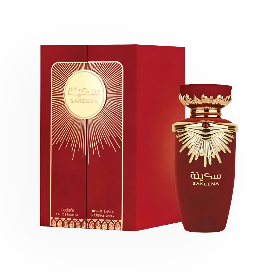 Flacon de parfum Sakeena Rouge de Lattafa accompagné de son packaging rouge intense. Le flacon, d’un rouge profond, est orné de détails dorés en forme de rayons et d’un capuchon élégant rappelant une couronne royale. La boîte rouge, décorée d’un disque doré central émanant des rayons lumineux, reflète un style somptueux et luxueux.